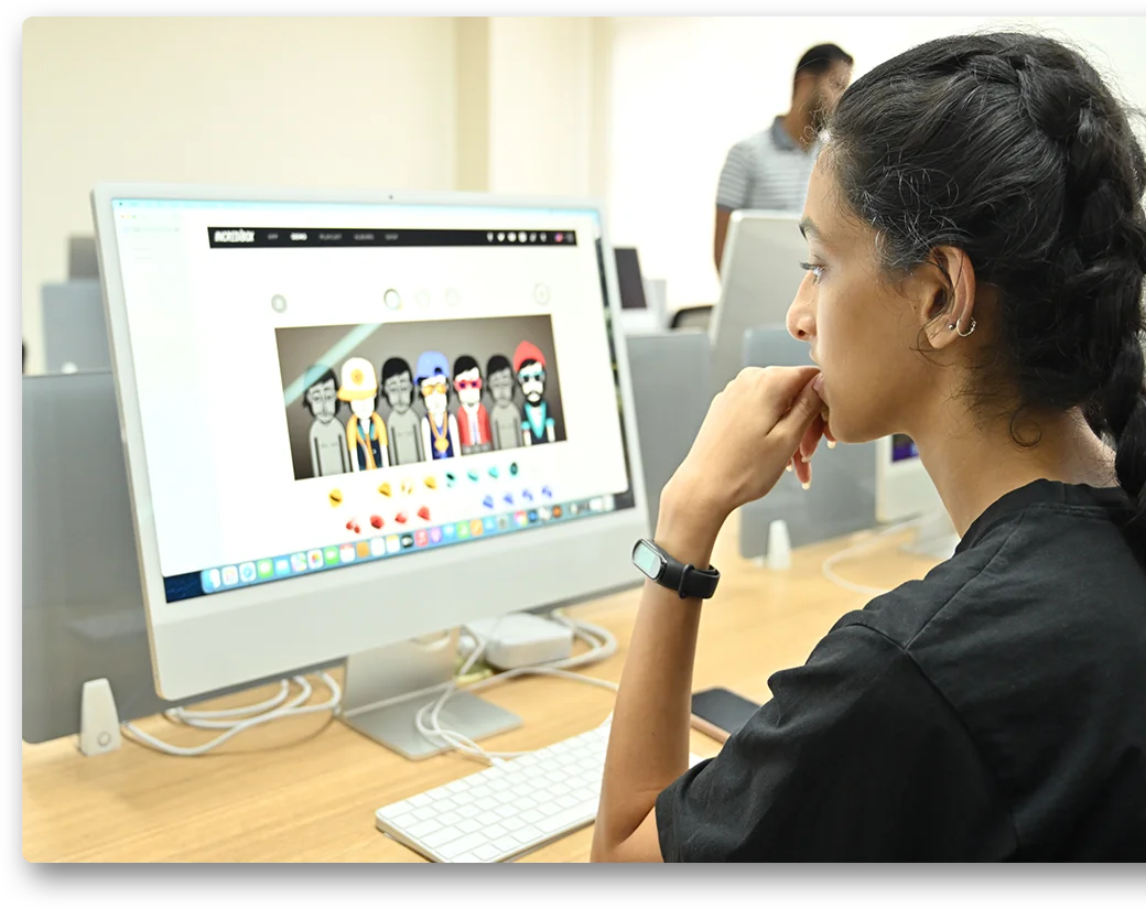 Student working on design at Mac